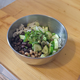 A small metal bowl on a wooden surface. It shows all the ingredients thrown in (except the apricot compot).