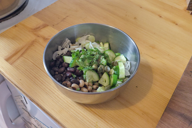 A small metal bowl on a wooden surface. It shows all the ingredients thrown in (except the apricot compot).